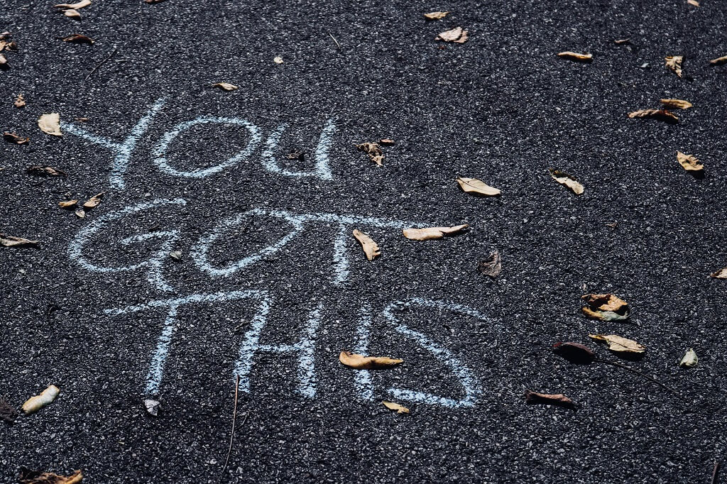 Encouragement shown in the photo. Large print written on the street says: "YOU GOT THIS" 