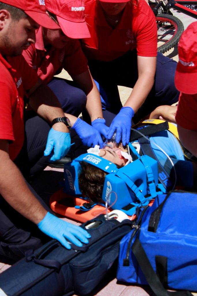 The photo shows what unnecessary risk can lead to. Emergency medical workers  are giving aid to an injured man lying on a stretcher. 
