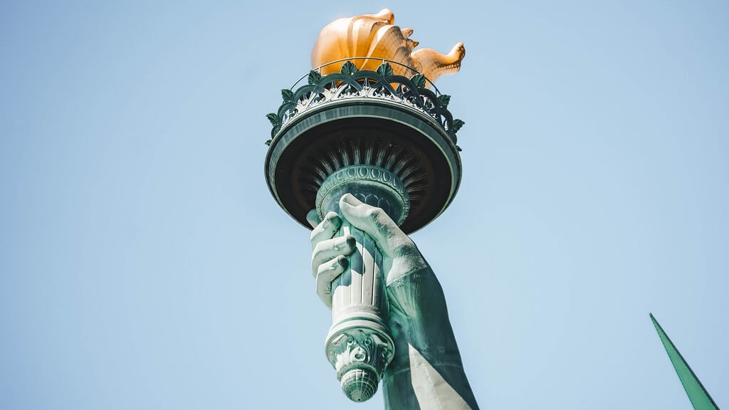 Photo shows the hand of the Statue of Liberty, holding up the torch of freedom.
